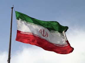 A big flag of Iran waving in the wind in Tehran, Iran.