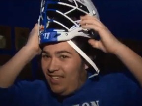 College lacrosse player Alex Chu was forced to sit on the bench because there’s no helmet that fits him. (YouTube/CBS Boston)