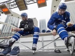 Toronto Maple Leafs Auston Matthews (left) and Mitch Marner tape their shinpads before the team's outdoor practice at Nathan Phillips Square in front of City Hall in Toronto on Thursday February 7, 2019. THE CANADIAN PRESS/Frank Gunn