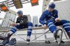 Toronto Maple Leafs Auston Matthews (left) and Mitch Marner tape their shinpads before the team's outdoor practice at Nathan Phillips Square in front of City Hall in Toronto on Thursday February 7, 2019. THE CANADIAN PRESS/Frank Gunn  
