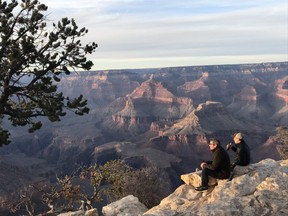 Tourists sit on the edge of the Grand Canyon - a must-see site for Arizona visitors. (Kim Pemberton photo)