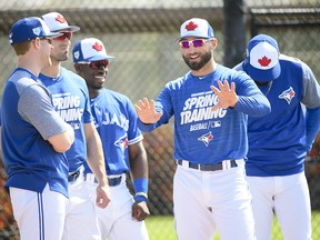 Toronto Blue Jays outfielder Kevin Pillar, centre, talks with teammates during spring training in Dunedin, Fla. on Tuesday, February 19, 2019. (THE CANADIAN PRESS/Nathan Denette)