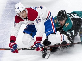 Canadiens forward Jesperi Kotkaniemi (left) is taken down by Ducks forward Rickard Rakell during first period NHL action in Montreal on Feb. 5, 2019.