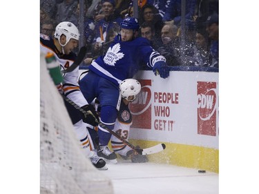 Toronto Maple Leafs Travis Dermott D (23) takes Edmonton Oilers Josh Currie RW (43) into the boards during the second period in Toronto on Wednesday February 27, 2019. Jack Boland/Toronto Sun/Postmedia Network