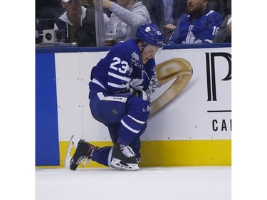 Toronto Maple Leafs Travis Dermott D (23) winces in pain after getting hit into the boards during the third period in Toronto on Wednesday February 27, 2019. Jack Boland/Toronto Sun/Postmedia Network