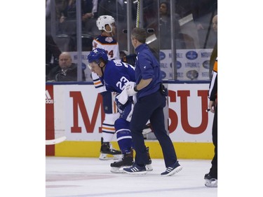 Toronto Maple Leafs Travis Dermott D (23) winces in pain after getting hit into the boards during the third period in Toronto on Wednesday February 27, 2019. Jack Boland/Toronto Sun/Postmedia Network