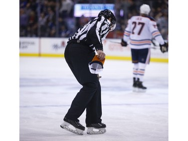 The ref picks up an Edmonton hat after the Leafs make it 5-1 during the second period in Toronto on Wednesday February 27, 2019. Jack Boland/Toronto Sun/Postmedia Network