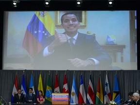 Prime Minister Justin Trudeau and Minister of Foreign Affairs Chrystia Freeland, bottom left, look on as Venezuelan Opposition Leader Juan Guaido makes brief remarks via video link at the opening session of the 10th ministerial meeting of the Lima Group in Ottawa on Monday, Feb. 4, 2019.