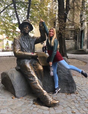 Lviv city guide Diana Borysenko, who also does genealogy tours, makes a wish at the monument of Ukrainian painter Nikifor Epifaniy Drovnyak. (Chris Doucette/Toronto Sun/Postmedia Network)