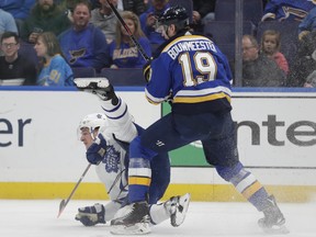 St. Louis Blues' Jay Bouwmeester (19) sends Toronto Maple Leafs' Zach Hyman (11) to the ice, after a collision during the first period in St. Louis on Tuesday night. (AP Photo/Tom Gannam)