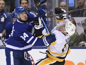 Maple Leafs centre Auston Matthews (left) runs into Pittsburgh Penguins counterpart Nick Bjugstad on Saturday night in Toronto. (Nathan Denette/The Canadian Press)