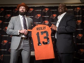 Quarterback Mike Reilly, left, poses for a photo with Lions GM Ed Hervey during a news conference after Reilly signed a four-year contract with the Lions, in Surrey, B.C., on Tuesday, Feb. 12, 2019.