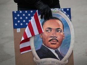 An activist holds a Martin Luther King Jr. sign in Chicago, Jan. 18, 2019.