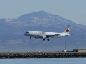 In this Oct. 24, 2017 file photo, an Air Canada plane prepares to land on a runway at San Francisco International Airport in San Francisco.