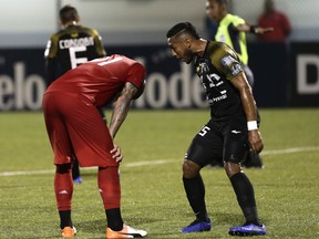 Terrence Boyd of TFC hangs his head — and takes some taunting from a CAI player — after missing a penalty kick in Tuesday’s 4-0 loss in Panama.  AP