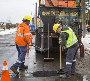 A city crew fills in a pothole near Lawrence Ave. E. and Don Mills Rd. in Toronto, Ont. on Friday February 22, 2019. (Ernest Doroszuk/Toronto Sun/Postmedia)