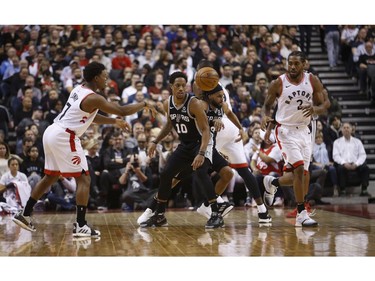 Toronto Raptors Kyle Lowry PG (7) passes the ball past San Antonio Spurs DeMar DeRozan SG (10) to teammate Kawhi Leonard (2) during the second quarter in Toronto, Ont. on Friday February 22, 2019. Jack Boland/Toronto Sun/Postmedia Network