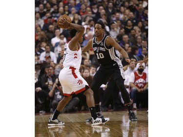Toronto Raptors Kyle Lowry PG (7) passes off in front of San Antonio Spurs DeMar DeRozan SG (10) during the second quarter in Toronto, Ont. on Friday February 22, 2019. Jack Boland/Toronto Sun/Postmedia Network