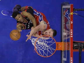 Toronto Raptors' Kyle Lowry, left, tries to get a shot past Philadelphia 76ers' Mike Muscala during the second half of an NBA basketball game Tuesday, Feb. 5, 2019, in Philadelphia. Toronto won 119-107. (AP Photo/Matt Slocum)