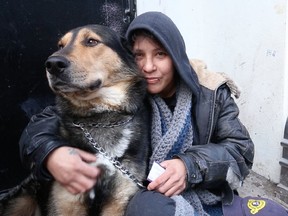 Sue and Rambo, who are among the countless youth living on the streets of Toronto. try to keep each other warm on Wednesday, Feb. 20, 2019. (Craig Robertson/Toronto Sun/Postmedia Network)