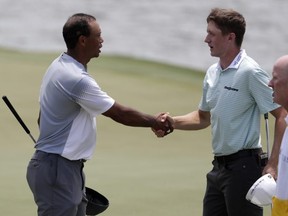 Tiger Woods shakes hands with Canadian Mackenzie Hughes on the 18th green during the third round of the Players Championship last May in 
Ponte Vedra Beach, Fla.  AP FILE