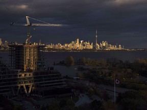 Condominiums are seen under construction in front of the skyline in Toronto, Ont., on Tuesday October 31, 2017. Home sales in Toronto and the surrounding area saw a small uptick in January, a sign that the real estate market in Canada's largest city remains stable.
