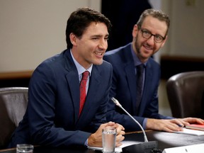 Canada's Prime Minister Justin Trudeau (L) and his principal secretary Gerald Butts take part in a meeting on Parliament Hill in Ottawa on April 21, 2017. (REUTERS/Chris Wattie)