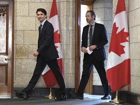 Prime Minister Justin Trudeau leaves his office with his then-principal secretary, Gerald Butts, to attend an emergency cabinet meeting on Parliament Hill in Ottawa on Tuesday, April 10, 2018. (THE CANADIAN PRESS/Justin Tang)