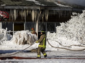 Firefighters during the second day of the fire at Agincourt Recreation Centre, near Midland Ave. and Sheppard Ave E. in Toronto, Ont. on Friday February 1, 2019.