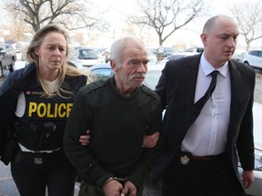 Police escort Michael Wentworth, 65, of Kingston into court for a bail hearing in Kingston, Ont. on Friday, Feb. 15, 2019. Wentworth is charged with nine crimes, including three counts of first-degree murder dating back to the mid 1990s and 2001. Elliot Ferguson/Postmedia Network
