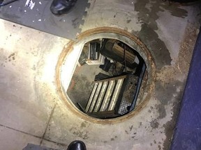 This Thursday, Feb. 7, 2019, photo released by the City of Fontana Police Department shows a manhole leading to an underground shooting range police found while searching the Southern California home of an alleged motorcycle gang in Fontana, Calif. The Fontana Police Department said on Facebook that officers discovered numerous weapons and thousands of rounds of ammunition that were seized during the search Thursday night. (City of Fontana Police Department via AP) ORG XMIT: LA603