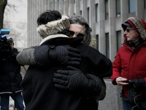 Shelly Kinsman is embraced by supporter Susan Gapka as she leaves The Toronto Courthouse in Toronto, Ontario on Friday, February 8, 2019 after the sentencing of Toronto serial killer Bruce McArthur. Shelly's brother Andrew Kinsman was one of McArthur's victims. - Canadian landscaper Bruce McArthur was jailed for life Friday for the murder and sexual mutilation of eight men from Toronto's gay community whose bodies he dismembered and hid in planters. McArthur, who admitted the killings last month, will be in his 90s before he is eligible for parole from eight concurrent 25-year sentences but Ontario Superior Court Justice John McMahon said he would likely never be released. (Photo by Cole BURSTON / AFP)        (Photo credit should read COLE BURSTON/AFP/Getty Images)
