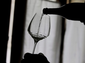 A man pours a bottle of Prosecco during a wine tasting at the Case Paolin farm, in Volpago del Montello, Italy on Oct. 15, 2018. A court placed Mike Weir Wine Inc. into receivership as the winery owes more than $6 million.