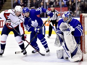 Washington Capitals’ Nicklas Backstrom (left) looks for a rebound as Maple Leafs’ Nikita Zaitsev and goaltender Frederik Andersen do the same during the third period last night in Toronto. (FRANK GUNN/THE CANADIAN PRESS)