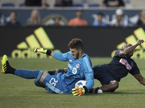 Toronto FC's Alex Bono makes the save on the shot by Philadelphia Union's Fafa Picault during a game last year. (AP PHOTO)