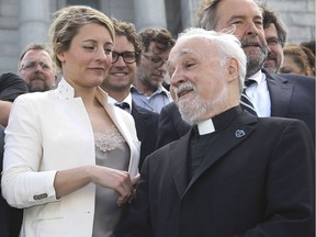 Mélanie Joly, minister of Canadian Heritage, speaks with Father Claude Grou, rector of St. Joseph's Oratory in 2016.