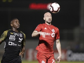 TFC's Laurent Ciman heads the ball past Ruben Barrow of Panama's Club Atletico Independiente FC last month. (AP PHOTO)