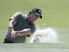 Phil Mickelson hits out of a bunker onto the second green during the first round of the Arnold Palmer Invitational on Thursday. (AP PHOTO)