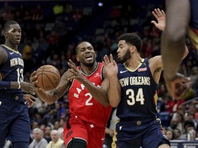 Toronto Raptors forward Kawhi Leonard drives to the basket against New Orleans Pelicans guard Kenrich Williams during Friday's game. (AP PHOTO)