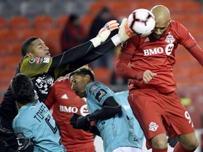 Toronto FC forward Terrence Boyd fails to make the header as Club Atletico Independiente goalkeeper Jose Guerra  punches the ball away last month. (THE CANADIAN PRESS)