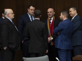 Liberal MPs and staffers gather and speak before a meeting of the justice committee in Ottawa on  March 19, 2019. (THE CANADIAN PRESS)