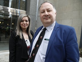 Catherine Petrolo stands with her representative Frank Alfano outside the Law Society of Ontario tribunal office, on University Ave., as she is fighting her temporary suspension of her paralegal licence on Friday, March 22, 2019. Jack Boland/Toronto Sun/Postmedia Network