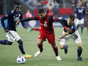 Toronto FC's Jordan Hamilton and New England Revolution's Antonio Delamea Mlinar (right) battle for the ball during a game last year. (AP PHOTO)