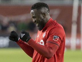 Toronto FC forward Jozy Altidore celebrates at the final whistle as his late goal sealed a 3-2 win over the New England Revolution on Sunday. (THE CANADIAN PRESS)