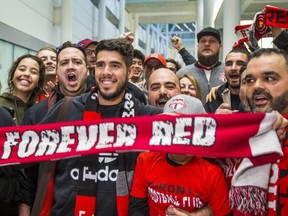 New TFC midfielder Alejandro Pozuelo poses with chanting fans after arriving at Toronto Pearson International Airport on Friday. (Ernest Doroszuk/Toronto Sun)