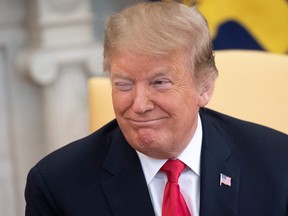U.S. President Donald Trump winks during a meeting with Israeli Prime Minister Benjamin Netanyahu in the Oval Office at the White House in Washington, DC, March 25, 2019.  (SAUL LOEB/AFP/Getty Images)