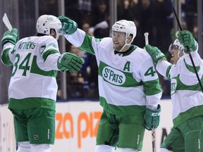 Maple Leafs centre Auston Matthews (left) celebrates after scoring the go-ahead goal on Flyers goaltender Brian Elliott with teammates during third period NHL action in Toronto on Friday, March 15, 2019.