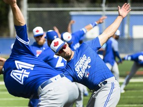 Blue Jays outfielder Randal Grichuk, stretching it out during spring training workouts, is slated to share the leadoff duties with Billy McKinney to open the season. Nathan Denette/Canadian Press