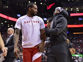 Toronto Raptors forward Kawhi Leonard, left, and teammate Kyle Lowry share a laugh during second half NBA basketball action against the Chicago Bulls in Toronto on Tuesday, March 26, 2019. THE CANADIAN PRESS
