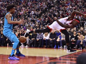 Toronto Raptors forward Pascal Siakam (43) saves a ball from going out of bounds as Charlotte Hornets guard Devonte' Graham (4) looks on during first half NBA basketball action in Toronto on Sunday, March 24, 2019. THE CANADIAN PRESS